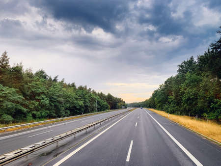 Asphalt road and beautiful nature landscape at sunsetの写真素材