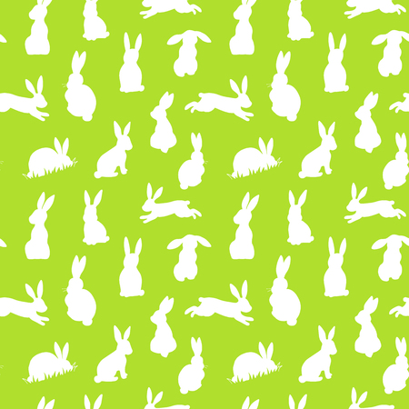 Seamless vector background with white easter rabbits silhouettes on a green backgroundのイラスト素材
