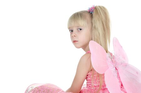 The girl in a pink dress with wings on a white backgroundの写真素材