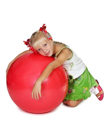 The girl with a greater red ball on a white backgroundの写真素材