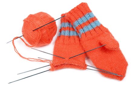 Children's mittens and ball of a wool with spokes for knittingの写真素材