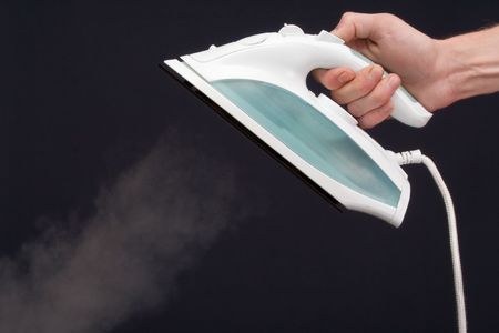 smoothing iron on a dark backgroundの写真素材