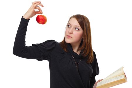 The girl with the book and a red apple on a white backgroundの写真素材