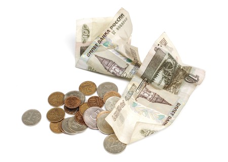 Paper money and coins are isolated on a white backgroundの写真素材