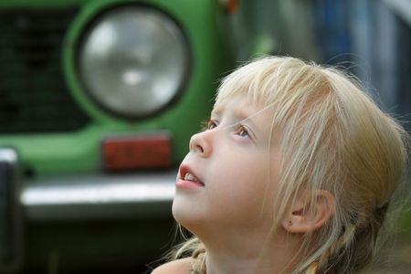 The girl on a background of the green carの写真素材