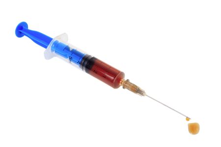Medical syringe with a medicine on a white backgroundの写真素材