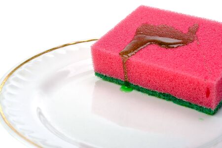 The sponge and plate to wash utensils on a white backgroundの写真素材