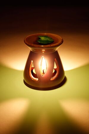 Candlestick with aromatization and a burning candleの写真素材