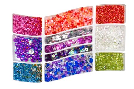 Multi-coloured beads of the different form in boxesの写真素材