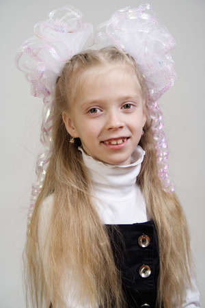 Portrait of the girl of the schoolgirl on a grey backgroundの写真素材
