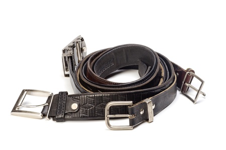 Old leather belts are isolated on a white background の写真素材