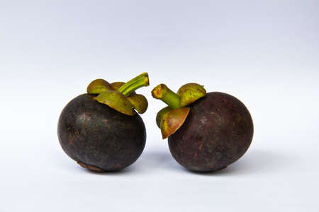 Two mangosteens on white backgroundの写真素材