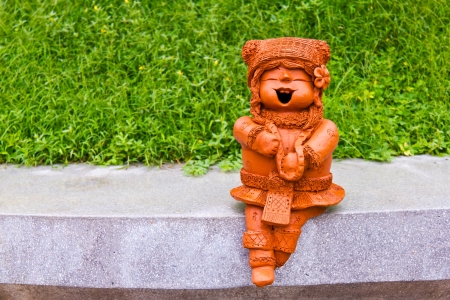 Smiling little girl, doll made by baked clay, for decoration, happy and peace conceptの写真素材