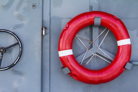 Life buoy on the battleship wall, a protective equipment in case of drowning, safety conceptの写真素材