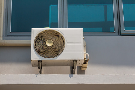 Wall mounted fan coil unit of air conditioner, installing outside of buildingの写真素材