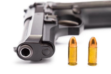 Close up of 9 mm. handgun focusing on the bullets and the muzzle of gun