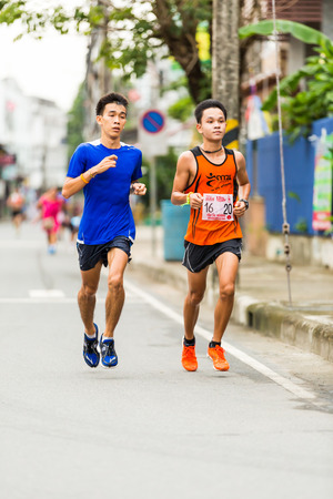 CHONBURI, THAILAND - 20 JULY 2014 - Unidentified athletes run in twelfth Walk and Run Phanat Nikhom Supper Mini-marathon race at Phanat Nikhom district, Chonburi, Thailand のeditorial素材