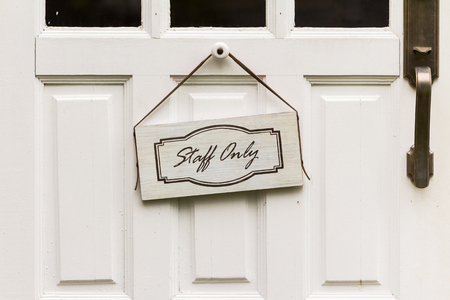 Staff only sign hangs on the wooden doorの写真素材