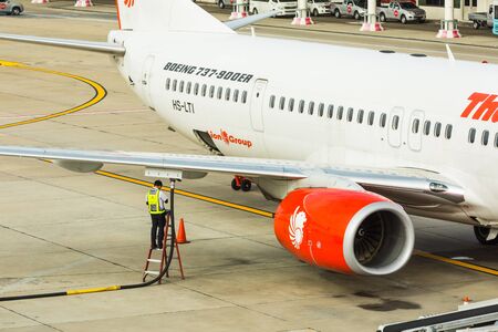 BANGKOK, THAILAND - 12 SEPTEMBER 2015 - Unidentified engineering worker works on underwing fueling...