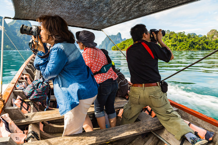 SURAT THANI, THAILAND - 13 SEPTEMBER 2015 - Unidentified tourists take photo from boat while travel...