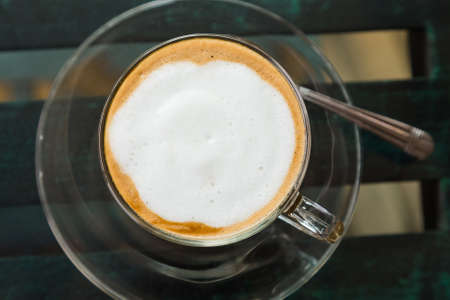 Hot coffee mocha on glass top table, top viewの写真素材
