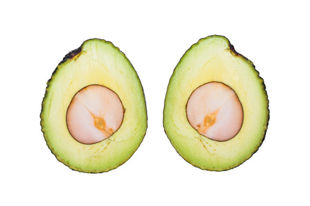 Avocado fruit in section showing the flesh, isolated on white background with clipping path