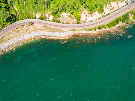 Aerial view from drone of coastal road with bike lane to Nang Phaya Hill Scenic Point in Chanthaburi, Thailandの写真素材