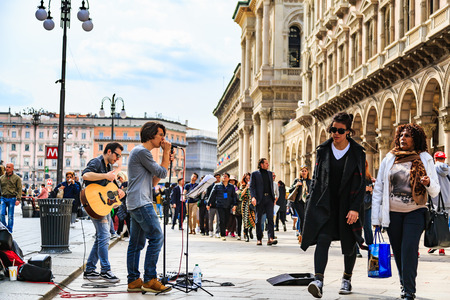 MILAN, ITALY - 14 APRIL 2018 - Unidentified street performers play guitar and sing the song in...