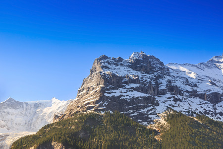 Snow-capped mountain in clear blue sky at Grindelwald, Switzerland