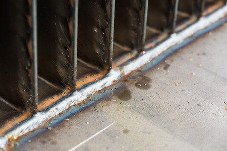 Welding seam by means of arc welding between corrugated fins and steel plate in transformer tank...