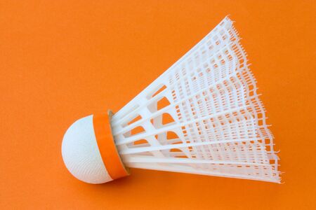 Close-up image of a badminton ball with orange background.の写真素材