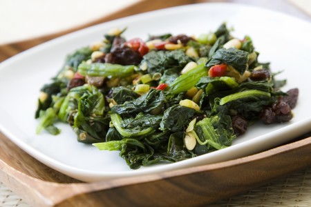 Indian cooked spinach with raisins, pine nuts and red pepper.の写真素材