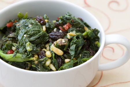 Indian cooked spinach with raisins, pine nuts and red pepper.の写真素材