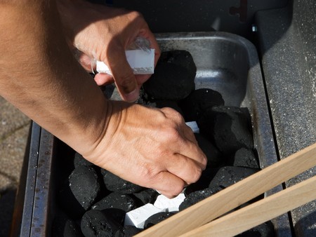 Outdoor image of a barbecue grill with coal which is set on fire.の写真素材