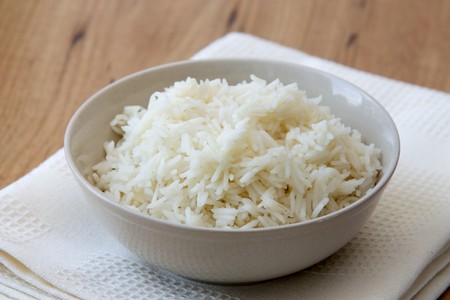 Bowl with rice photographed in vintage style with old dish towel.の写真素材