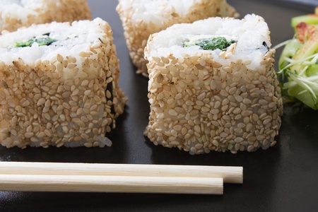 Selective focus image of ura maki sushi rolls with Japanese cucumber saladの写真素材