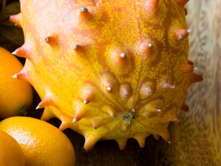Selective focus image of a horned melon and cumquats.の写真素材