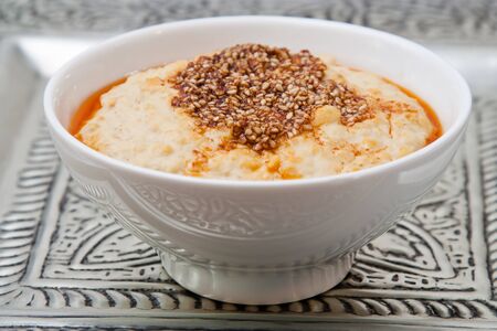 White bowl with Oriental chickpeas puree which is also called hummus.の写真素材