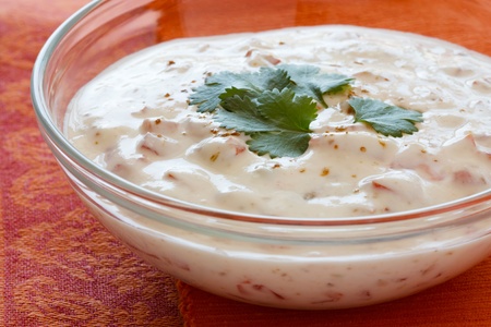 Indian yogurt dip with tomatoes and cilantro which is also called raita.の写真素材