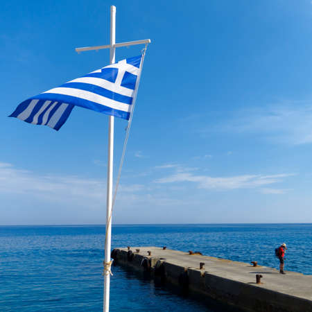 Harbour with pier and the Greece flag.の写真素材