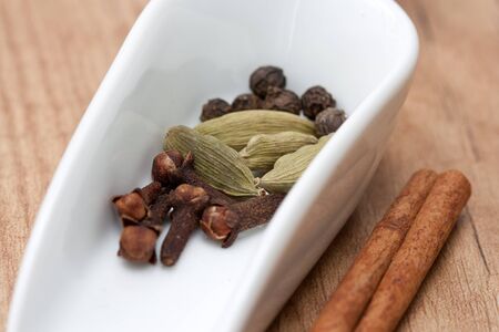 Typical Indian spices like cloves, cinnamon, pepper and cardamom.の写真素材