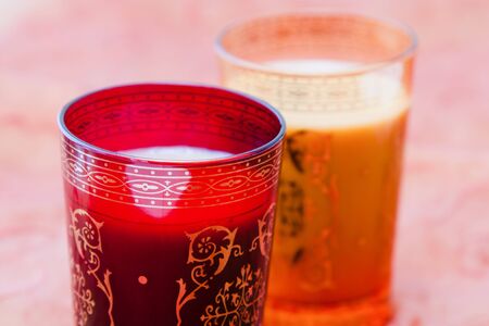 Image of Indian glasses with chai tea in red and orange colors.の写真素材