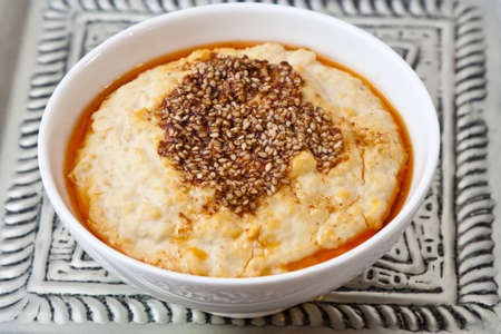 White bowl with Oriental chickpeas puree which is also called hummus.の写真素材