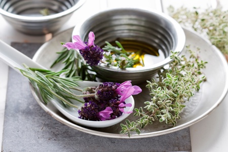 Summer still life showing lavender, oil, rosemary and thyme.の写真素材
