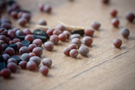 Selective focus macro image of mustard seed on a wooden board.の写真素材
