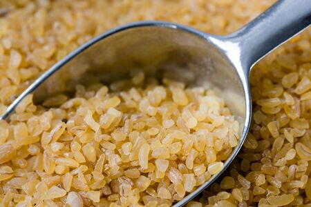 Full frame image of uncooked bulgur with a chute.の写真素材