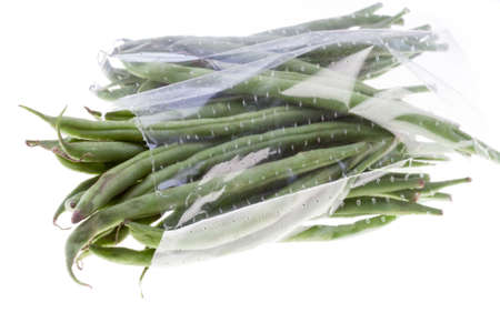 Isolated green beans in a plastic bag with white background.