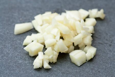 Selective focus image of chopped garlic on a stone plate.の写真素材