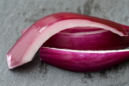 Selective focus image of chopped red onions on a stone plate.の写真素材