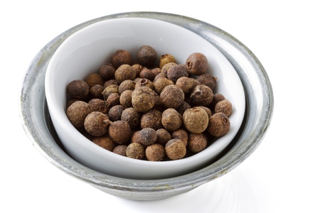 Small bowl with allspice and white background.の写真素材
